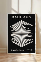The image is a poster for the Bauhaus art school in 1919, featuring a minimalist design with a geometric pattern and bold text.