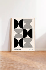 a minimalist art print with a geometric design composed of circles and lines in black and white.
