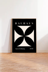 a poster of the Bauhaus art school, with a black and white geometric design and the text "Bauhaus" prominently displayed.