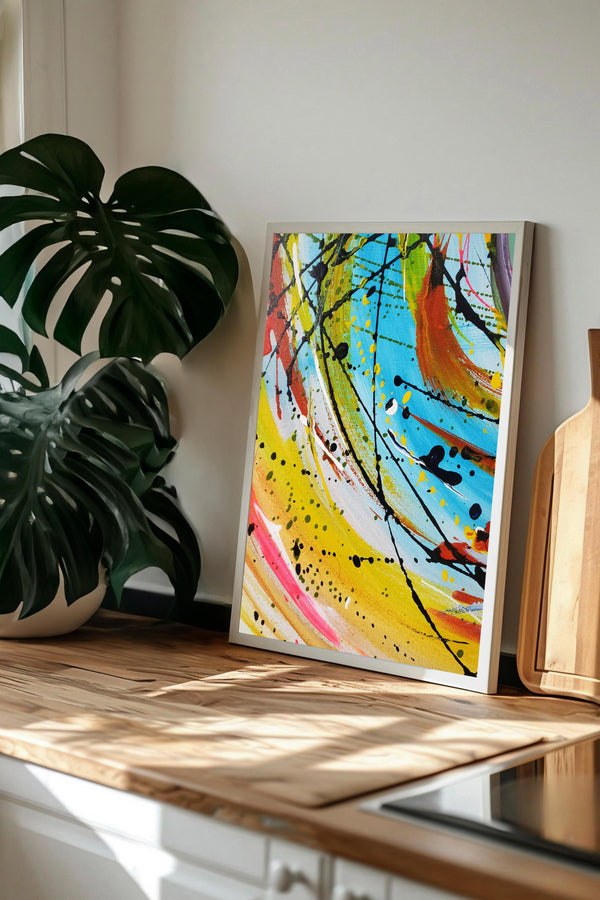 a vibrant abstract painting with bold colors and dynamic brushstrokes, displayed on a wooden surface.