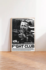 A framed poster of a man with a wide smile on his face, standing in a room with a wooden floor.