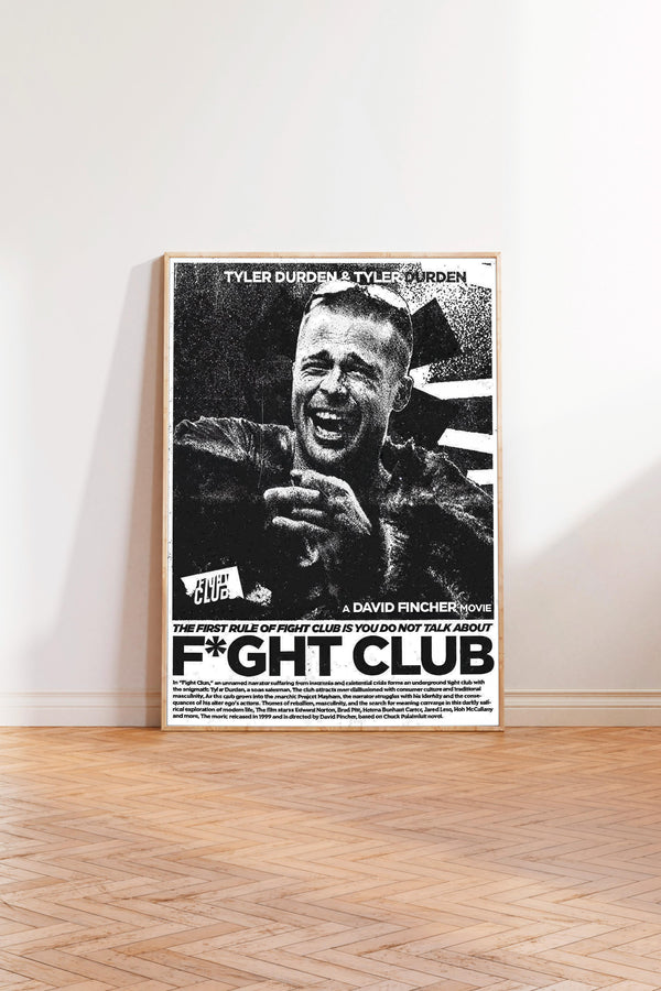 A framed poster of a man with a wide smile on his face, standing in a room with a wooden floor.