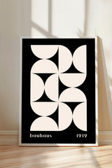 a minimalist black and white poster with a geometric design composed of circles and lines.