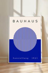 a poster with the text "BAHAUX" and "AUSTELLUNG 1923" on it, along with a blue circular design.