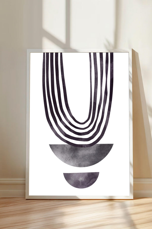 a minimalist art piece with a bold, abstract design consisting of a large, curved line and two smaller, circular shapes below it. The art piece is displayed on a white wall, and the wooden floor beneath it adds a warm, natural element to the overall composition.