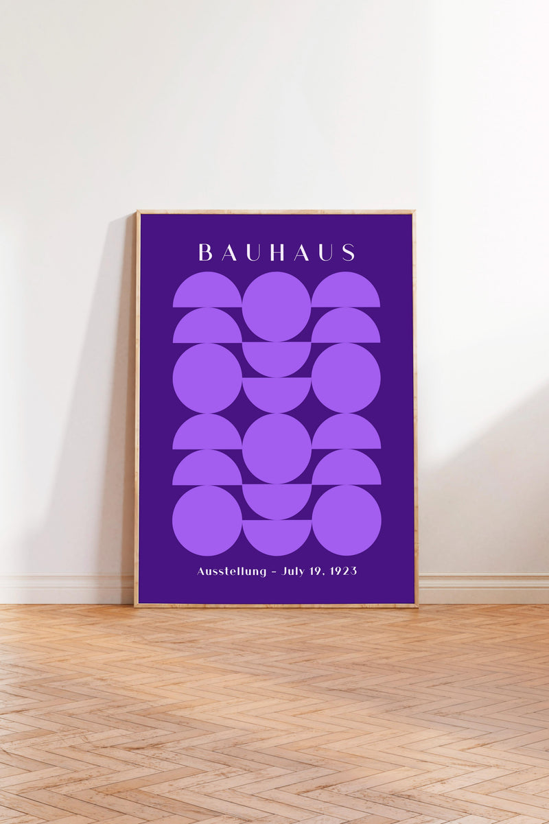 a poster with a purple background and a geometric design of circles and ovals. The poster is titled "BAHAU" and is displayed on a wooden floor against a white wall.
