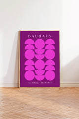 a poster with a bold purple background and a geometric design of circles and ovals. The text on the poster reads "BAHAUX" and "Ausstellung - July 19, 1925".