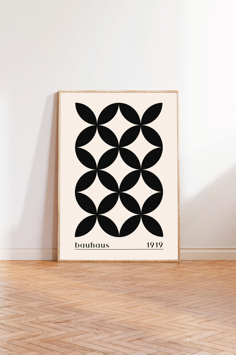 a minimalist black and white geometric design with a repeating pattern of circles on a beige background.