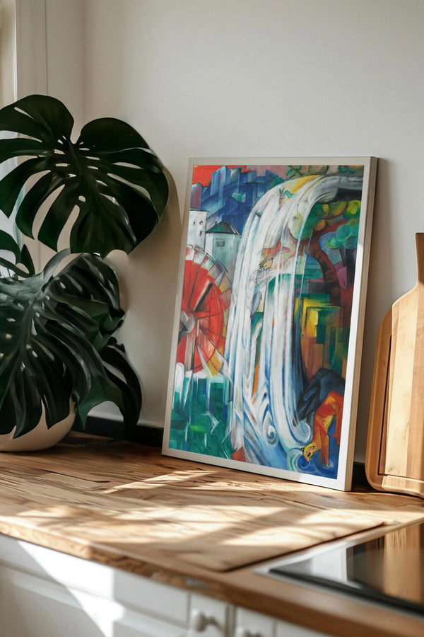 a vibrant abstract painting displayed on a wooden surface, with a large potted plant to the left.