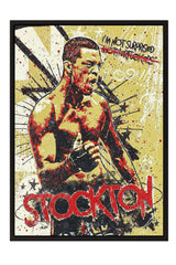 The image is a framed poster featuring a muscular man with a determined expression, surrounded by a vibrant, graffiti-style background.