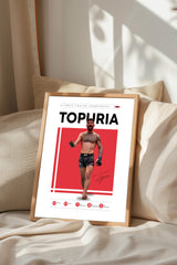 a framed poster of a man with a tattoo, standing in front of a red background.