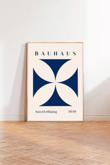 a poster of the Bauhaus art school, with a large blue and white geometric design in the center.