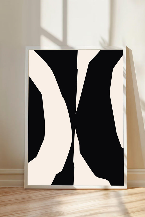 a large abstract artwork with bold black and white shapes, displayed on a white wall.
