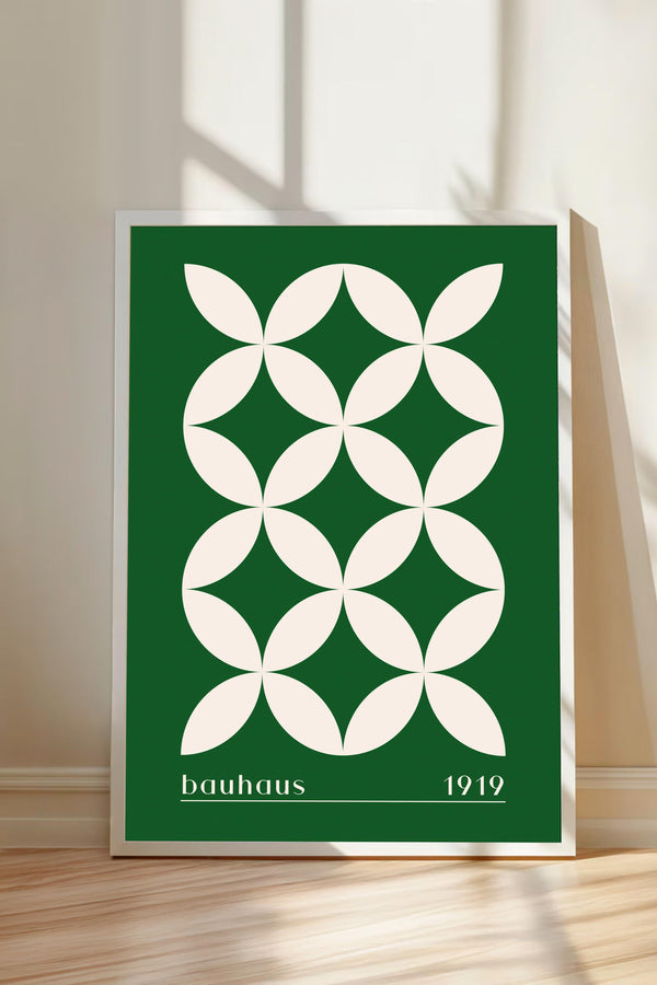A framed poster with a geometric design in green and white colors, featuring a repeating pattern of white circles on a green background.