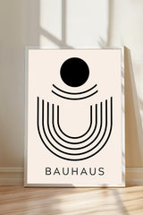 a minimalist poster with a bold black circle and lines, and the word "BAHAU" written below it.