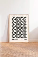 a minimalist poster of Bauhaus architecture from 1919, with a repeating geometric pattern in black and white.
