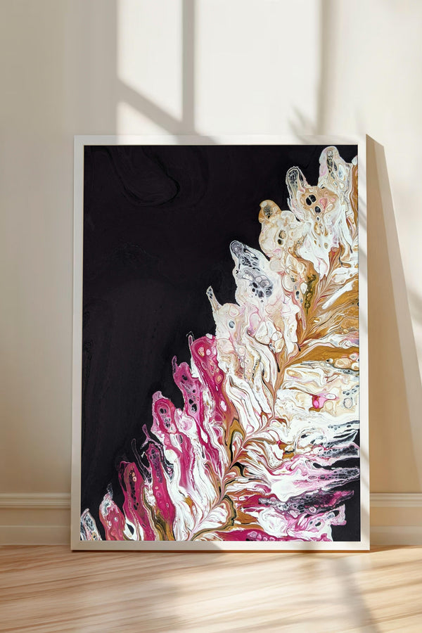 a vibrant abstract painting with a striking contrast of black and white, accented by splashes of pink and white. The painting is framed and displayed on a wooden floor, with a shadow cast on the wall behind it.