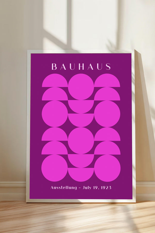 a poster with a geometric design in shades of pink and purple, displaying the name "BAHAU" and the date "July 19, 1923" at the bottom.