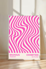 A poster for the Bauhaus exhibition in Frankfurt, Germany, which features a pink and white striped design.