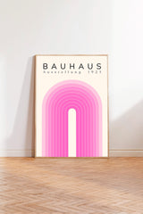 a poster of Bauhaus, a famous art school, with a pink and white color scheme.