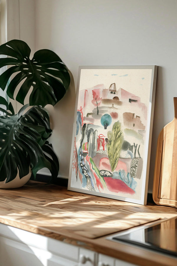 a framed watercolor painting of a desert landscape, with a large green monster plant in the foreground.