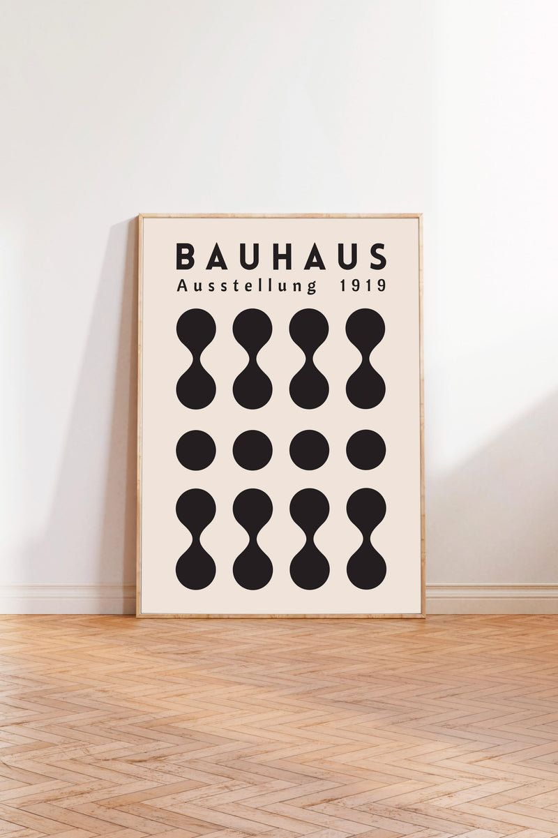 a poster of Bauhaus, a famous art school, with a minimalist design consisting of black circles arranged in a grid pattern.