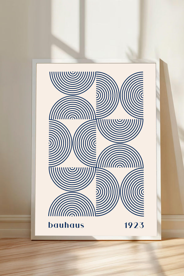 A framed poster with a minimalist design featuring concentric circles in shades of blue and white.