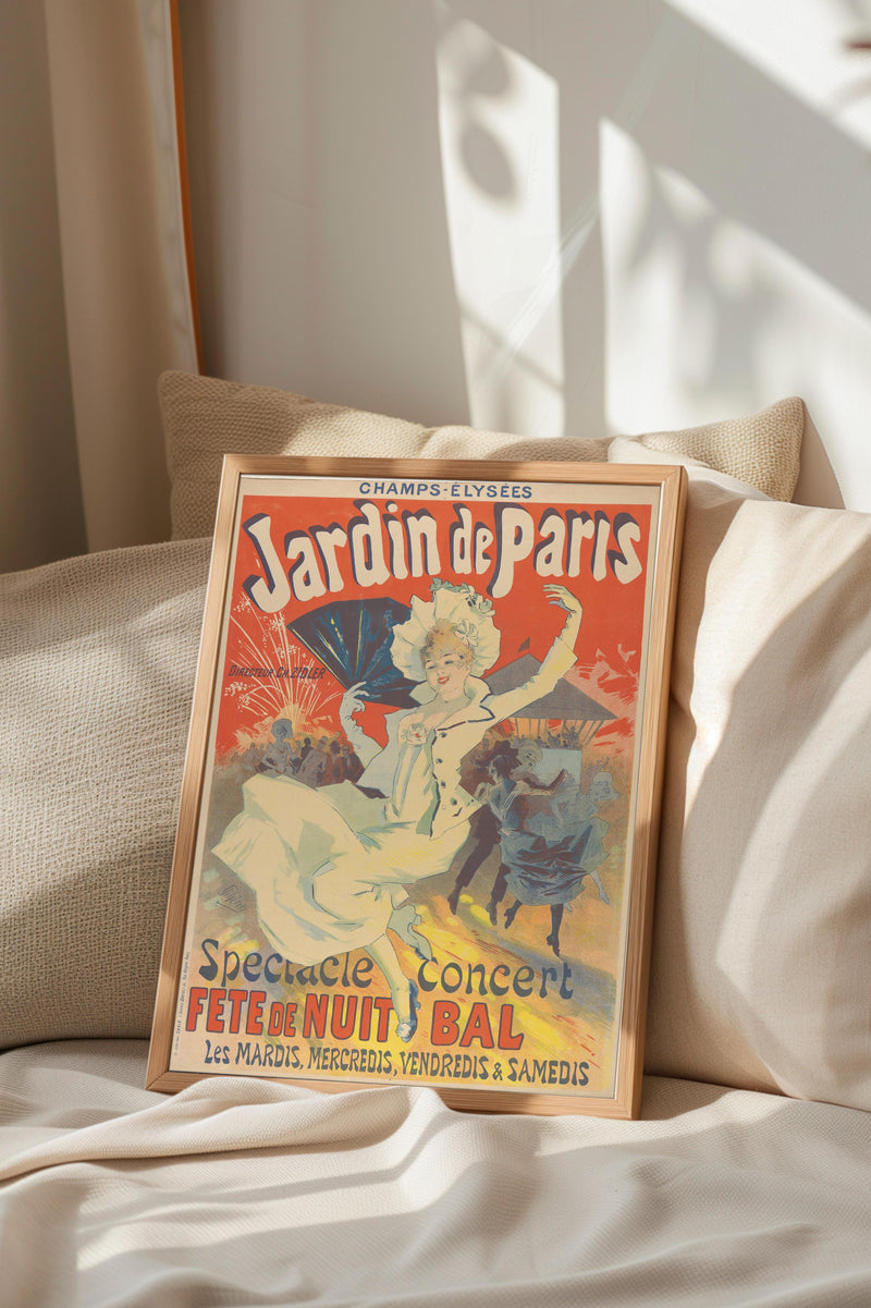 A framed vintage poster advertising a special event called "Jardin de Paris" is displayed on a bed with a beige pillow.