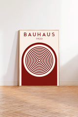 a poster of Bauhaus, a famous art school and architect, with a red and white color scheme and a circular design element.
