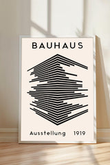 The image is a poster for the Bauhaus art school, featuring a geometric design with lines and shapes in black and white.