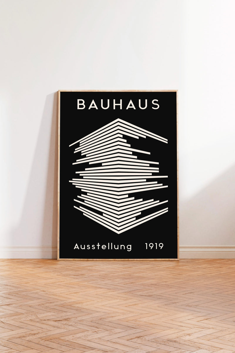 a poster of the Bauhaus, a famous art school founded by Walter Gropius in 1919. The poster has a black background with a white geometric design and the text "Bauhaus" prominently displayed.