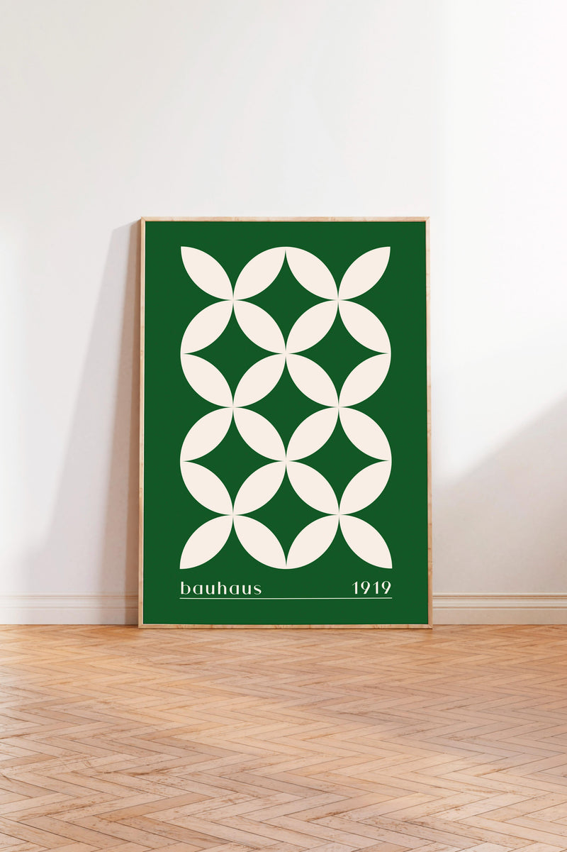 A framed poster with a geometric design in green and white colors, featuring a repeating pattern of white circles on a green background.