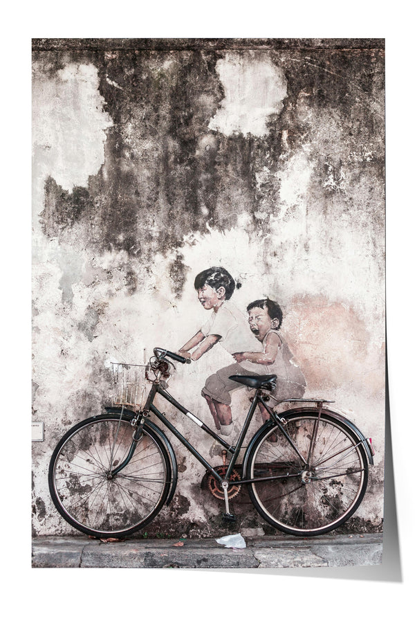 A black bicycle is parked in front of a weathered concrete wall, with two figures depicted on the wall, one of whom is riding the bicycle.