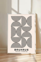 The image is a framed poster featuring a minimalist design with a repeating pattern of circles and lines in black and white.