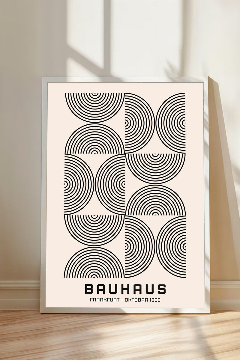 The image is a framed poster featuring a minimalist design with a repeating pattern of circles and lines in black and white.